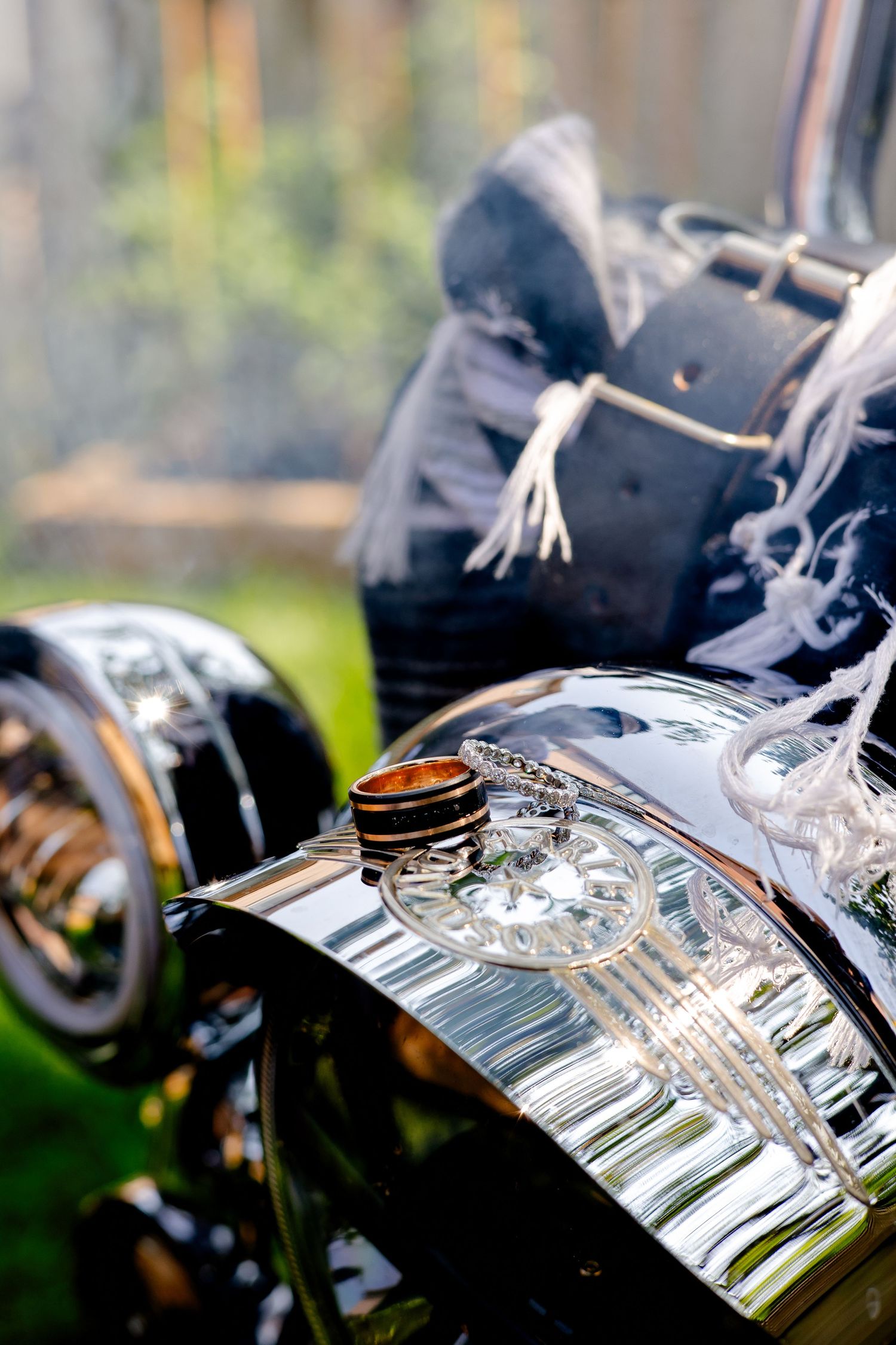 Close-up of vintage motorcycle chrome details with decorative rings.