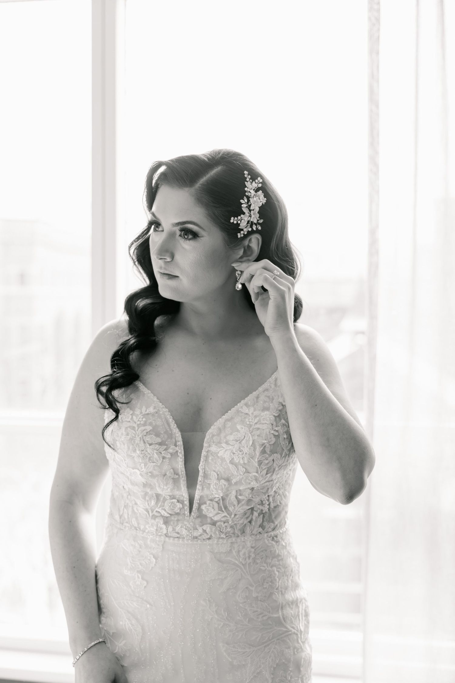 Black and white bridal portrait featuring elegant lace gown and vintage-inspired hair styling.
