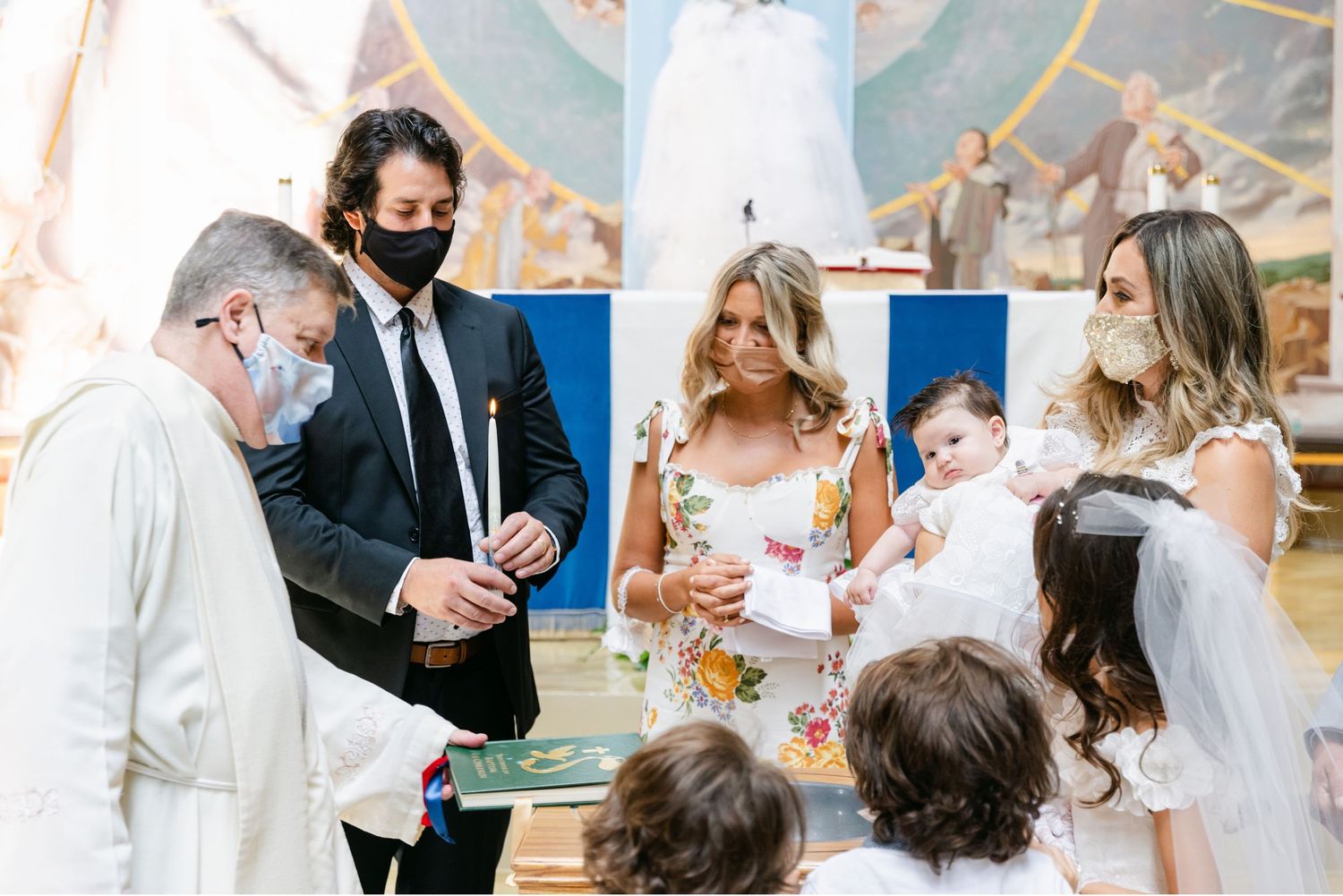 Religious ceremony in a church with attendees wearing face masks during a special service.