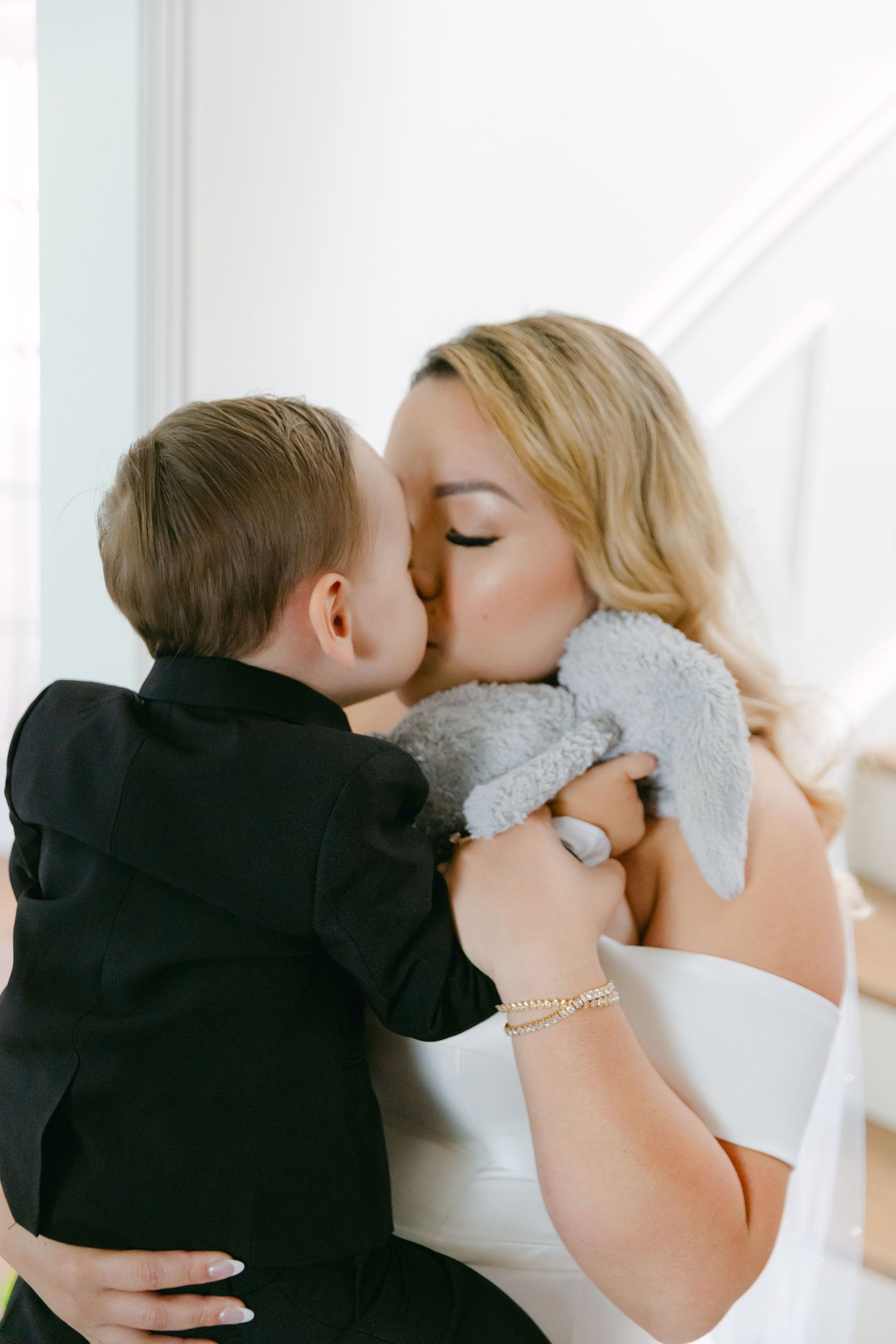 An intimate moment captured between a bride and young child on her wedding day.