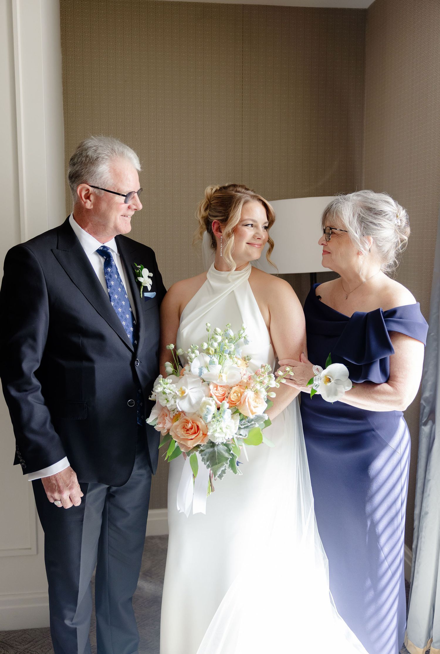 Wedding party sequence showing formal portraits with navy and white attire and peach floral bouquet.