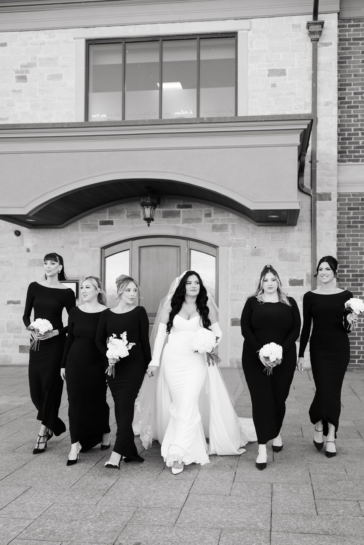 Black and white photo of wedding party in coordinated black and white attire.