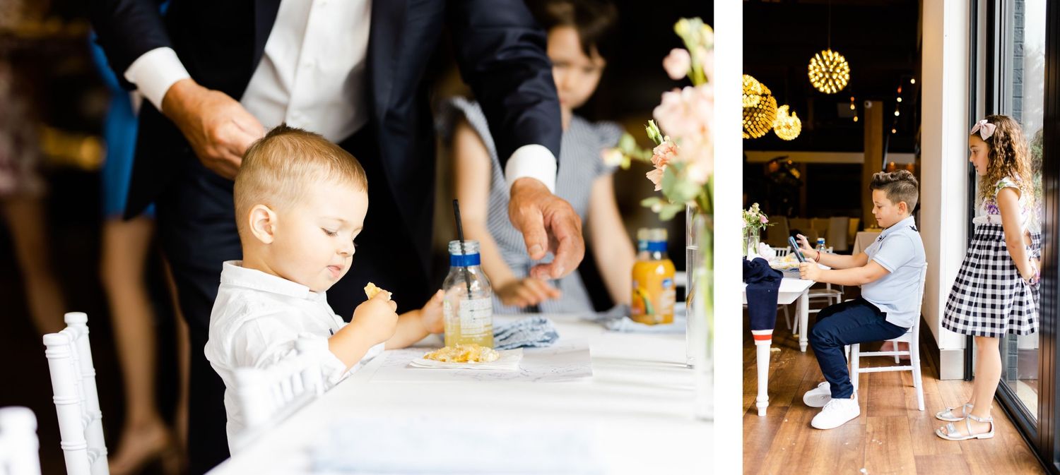 Children enjoying themselves at a formal event near dining tables.