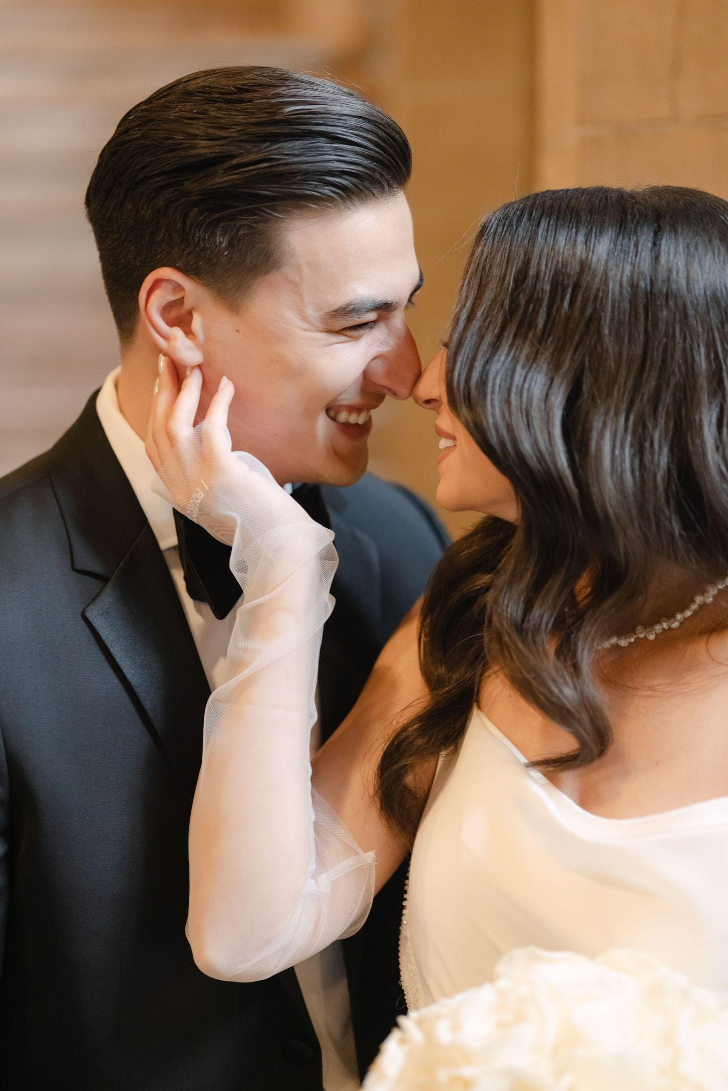 Romantic close-up of couple sharing an intimate moment during wedding photoshoot.