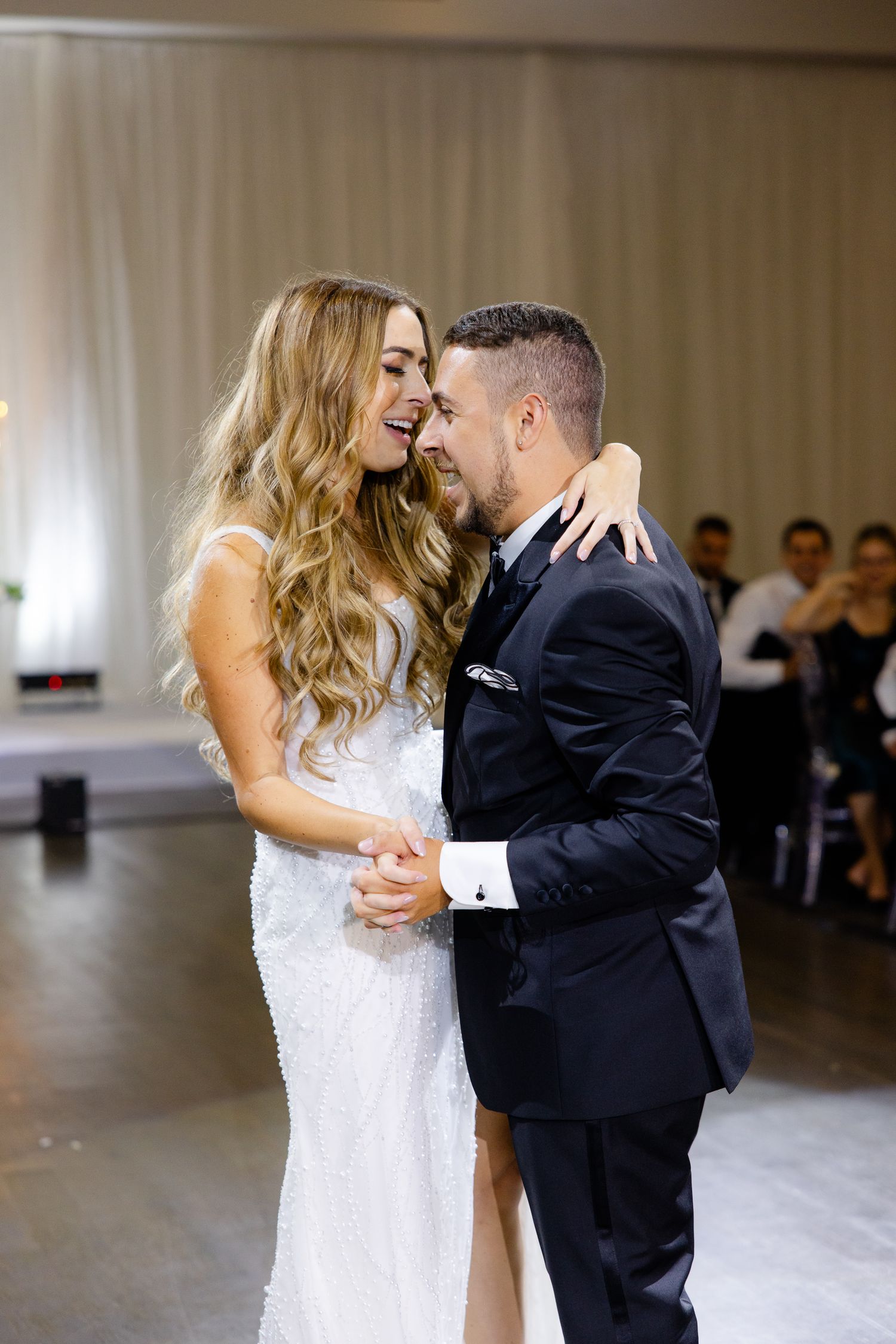 Intimate moment shared between couple during wedding dance in elegant reception venue.