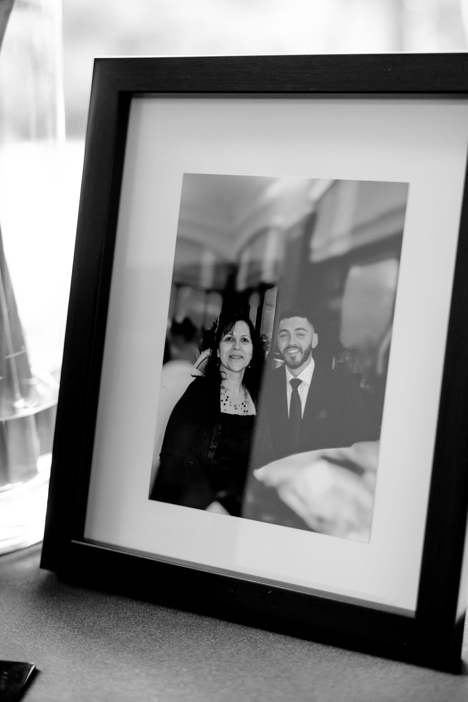 Black and white framed photograph displayed at wedding reception.