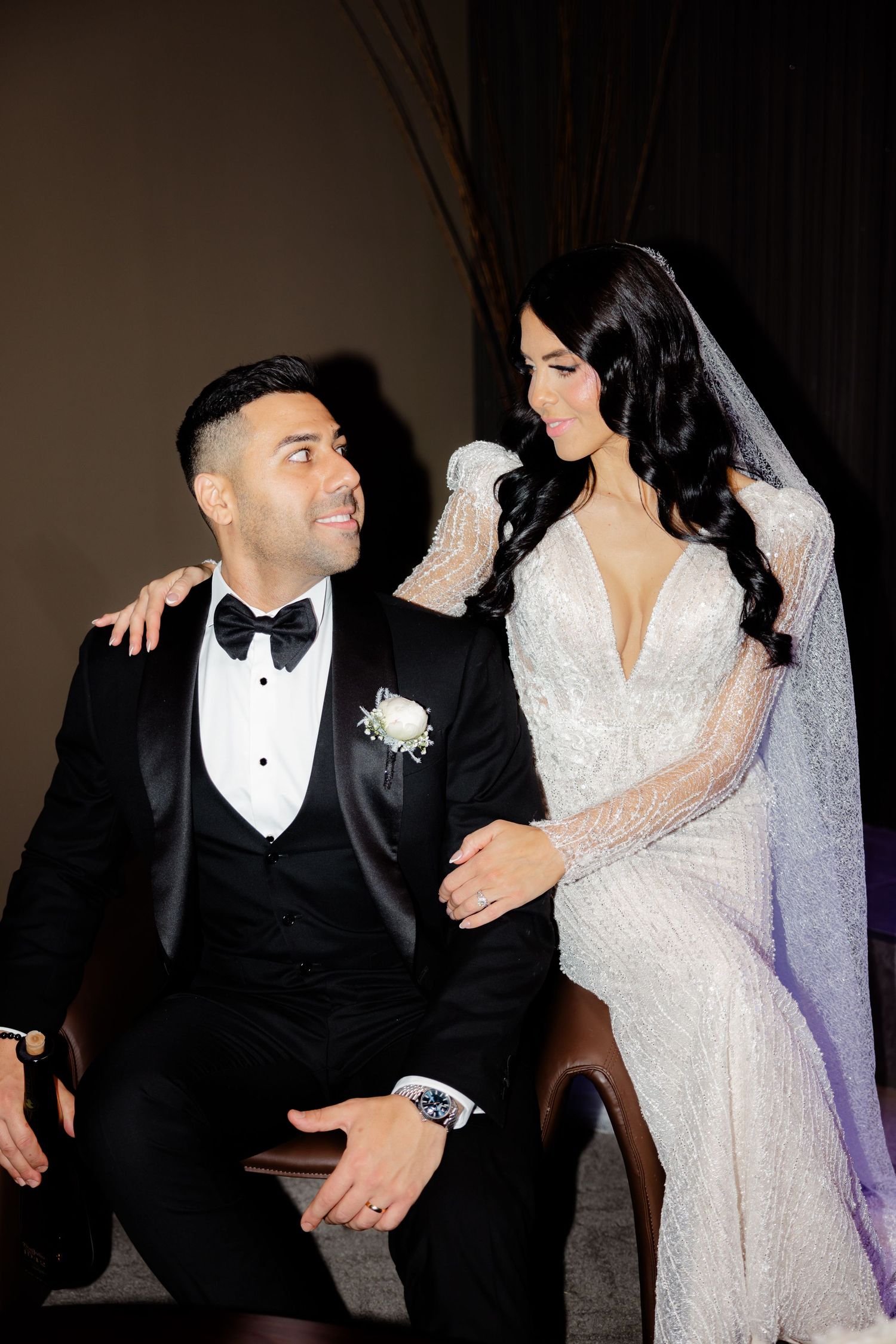 Stylish bride and groom share candid moment during wedding photo session.