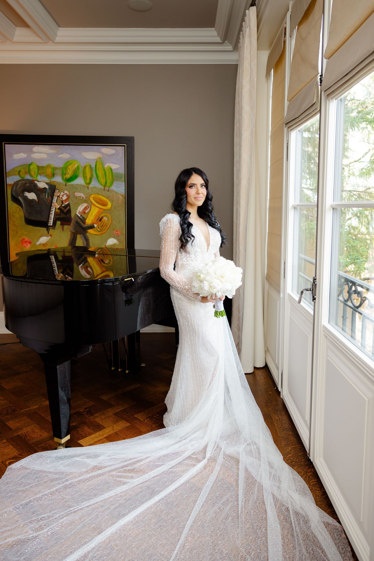 Elegant bridal portrait showcasing dramatic train and modern venue details.