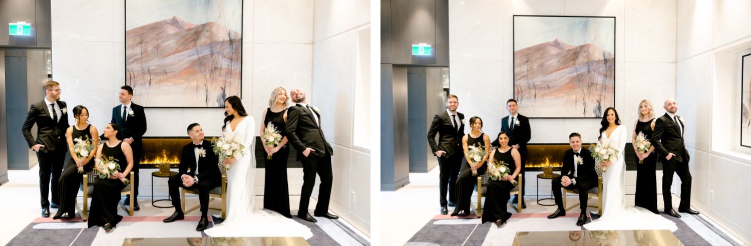 Wedding party group photo featuring modern interior design with abstract artwork and fireplace.
