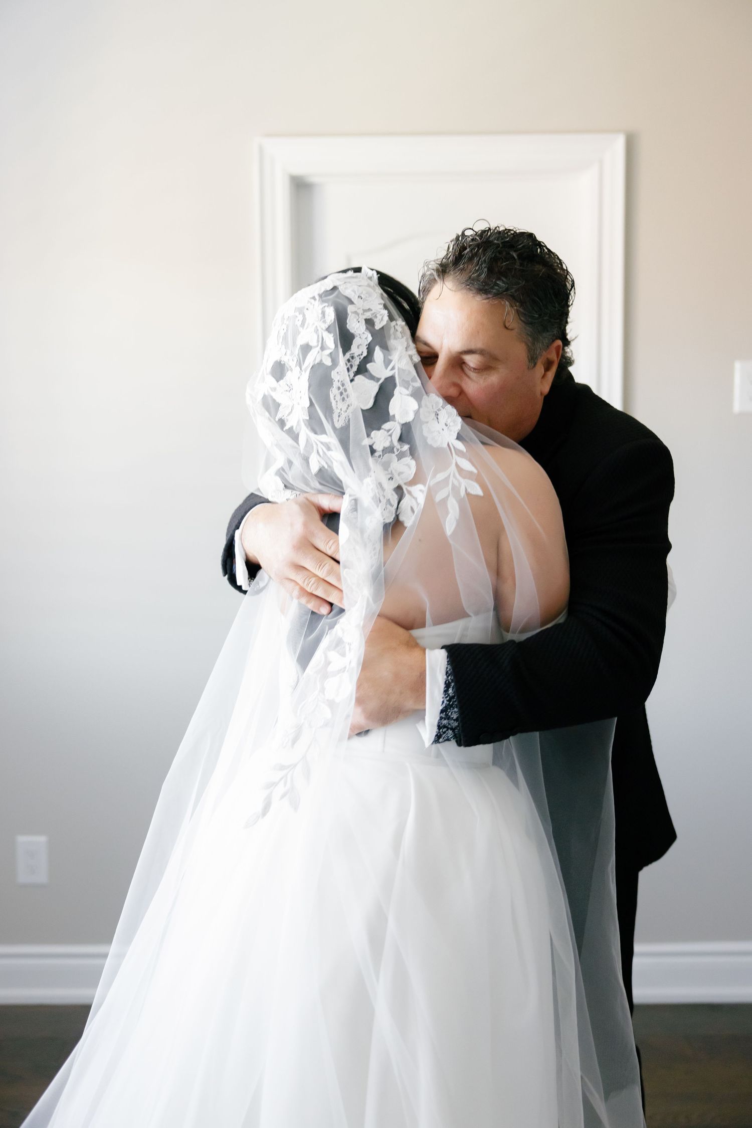 An intimate embrace between newlyweds during their first look moment.
