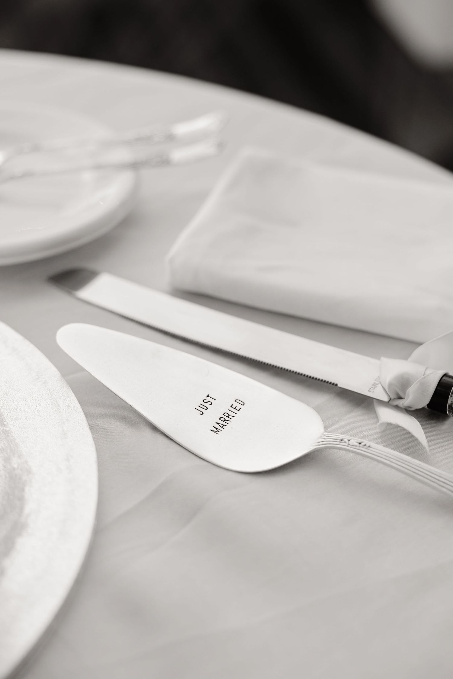 Black and white detail shot of minimalist wedding place cards on a white surface.
