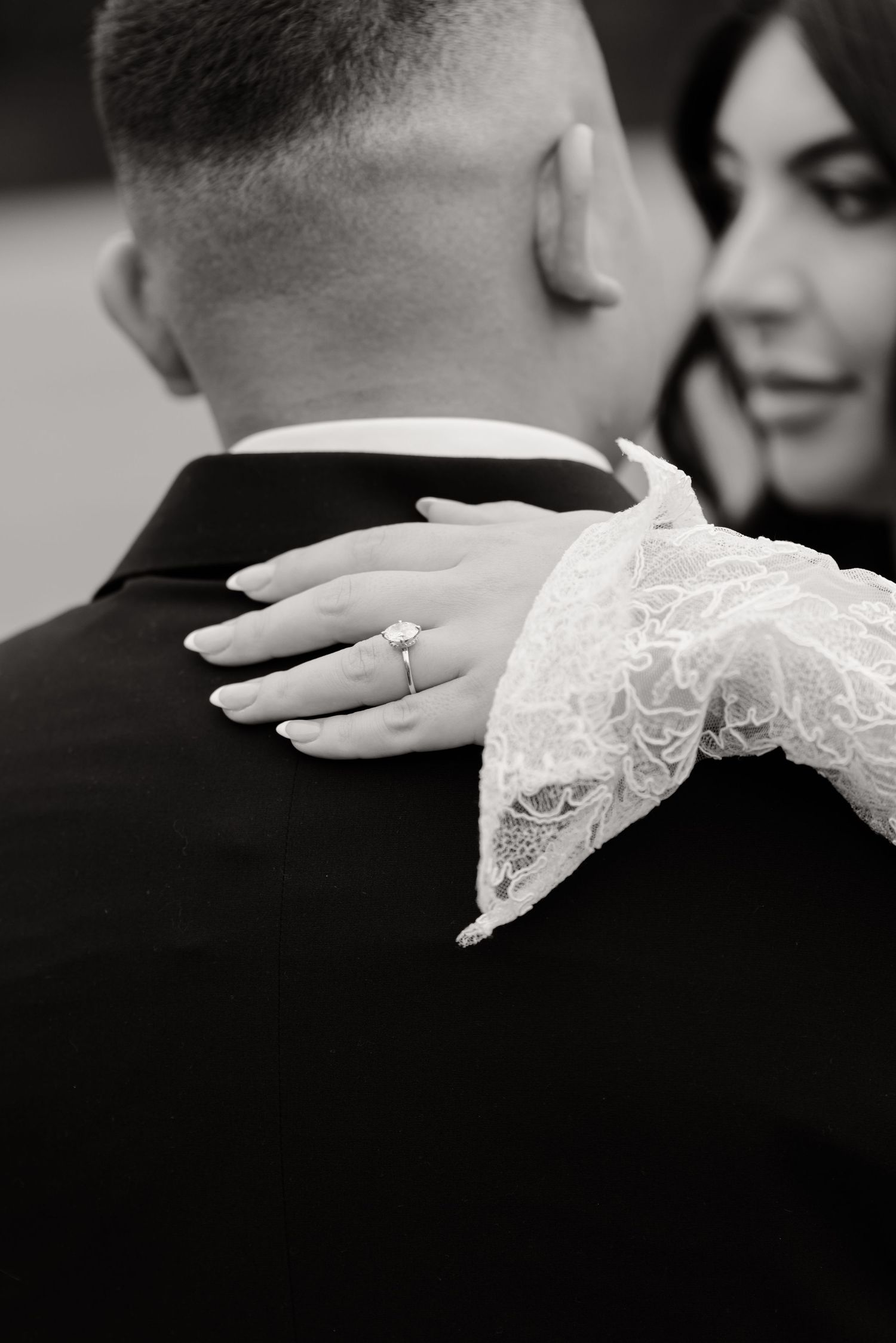 A series of close-up shots showing a delicate lace wedding sleeve against a black suit.