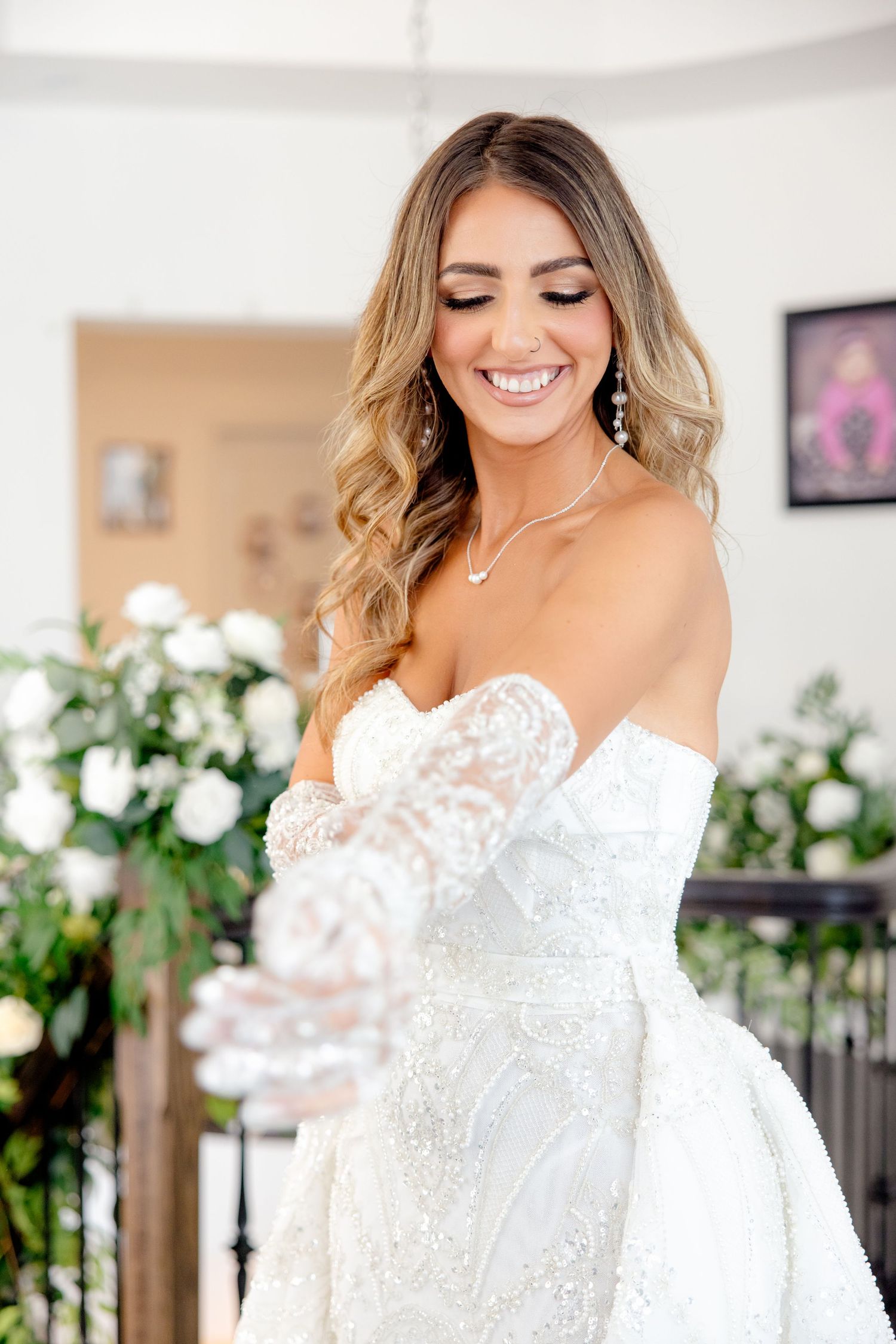 Close-up bridal portrait showcasing detailed lace wedding gown and elegant jewelry.