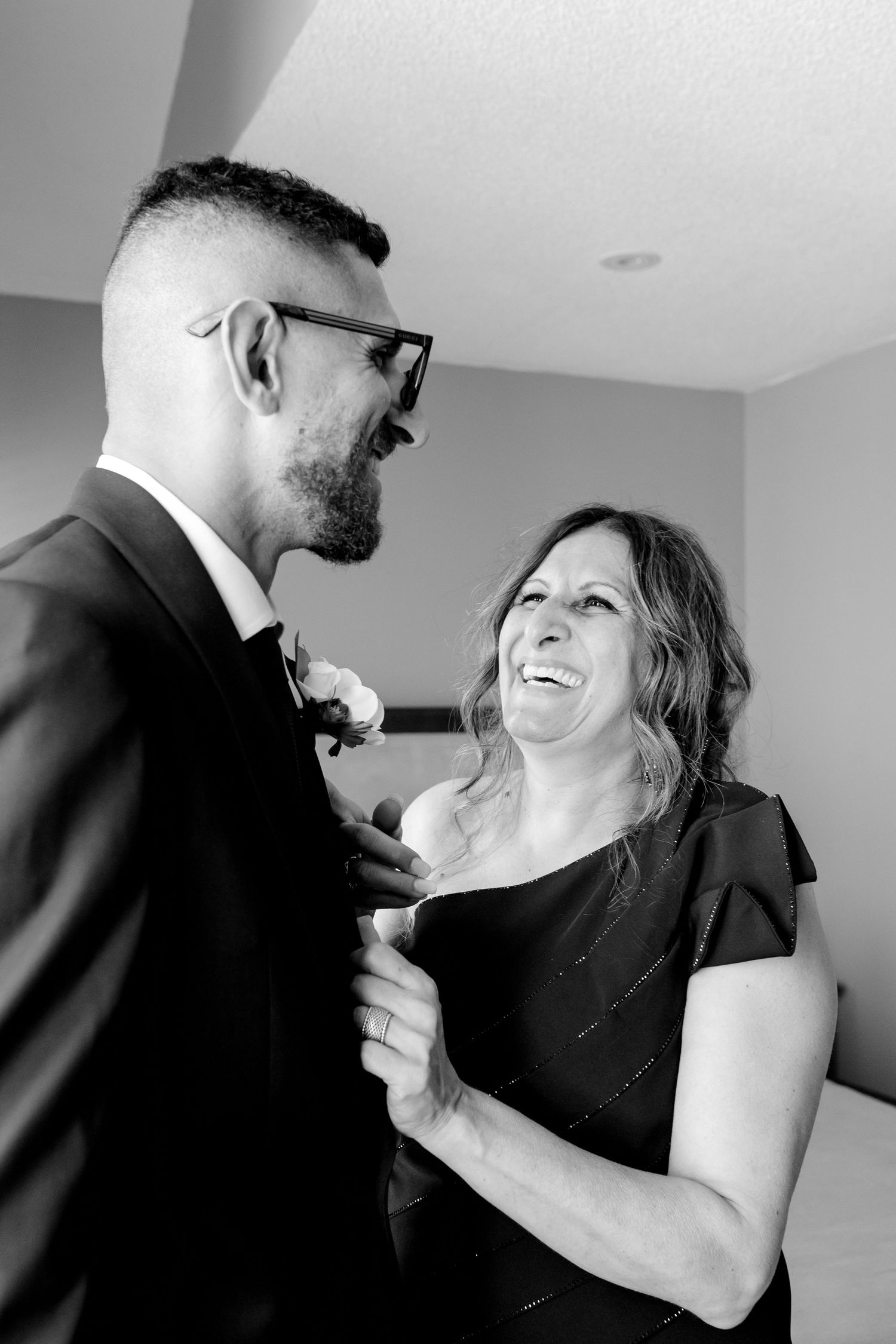 A candid moment of shared laughter during formal event preparations.