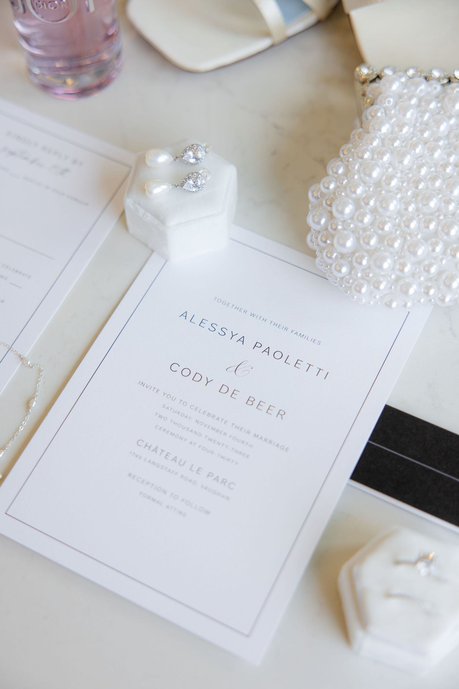 Wedding invitation for Alessya and Cody with pearl clutch and jewelry box.