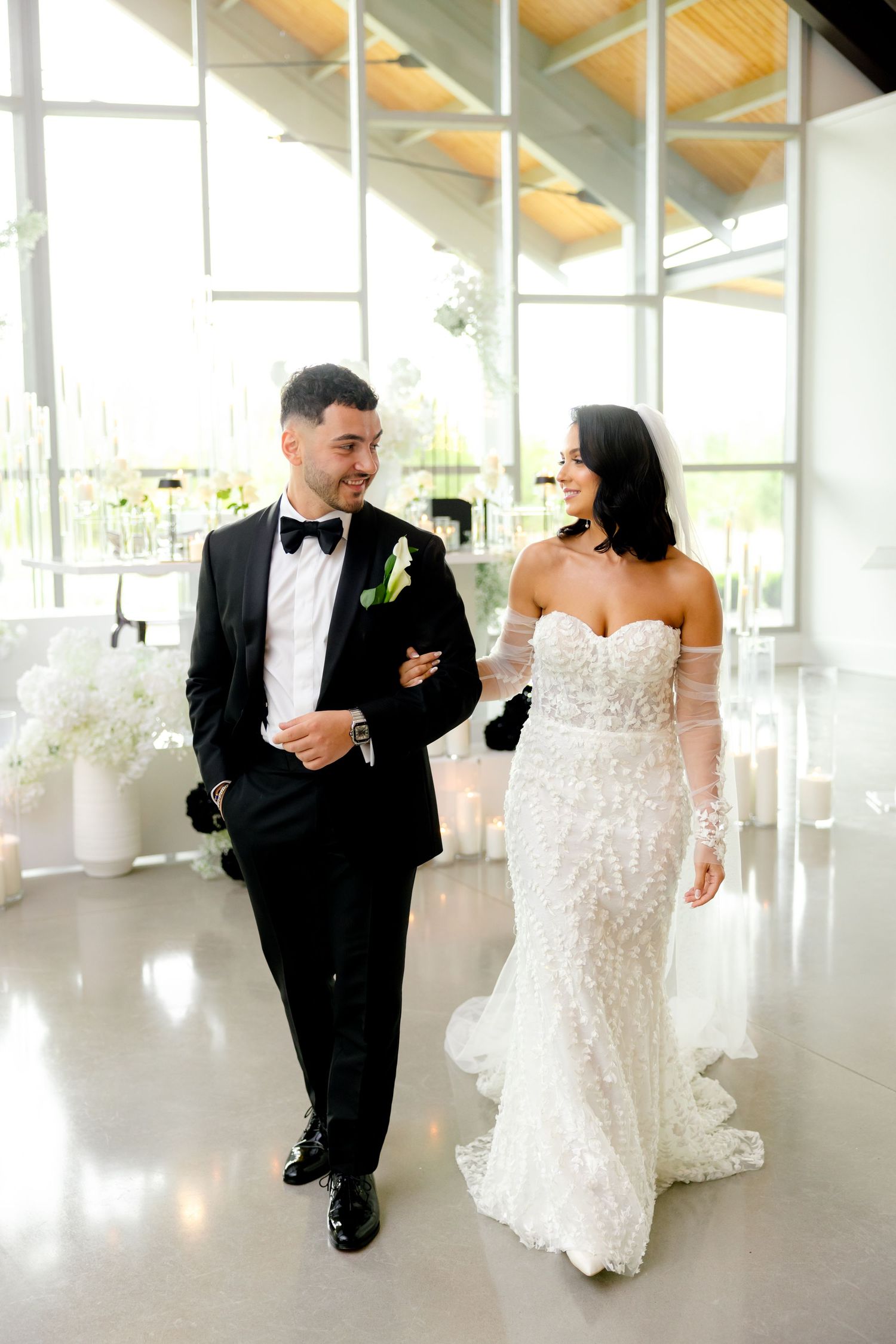 Elegant wedding venue interior with vaulted ceilings and large windows creating beautiful natural light.