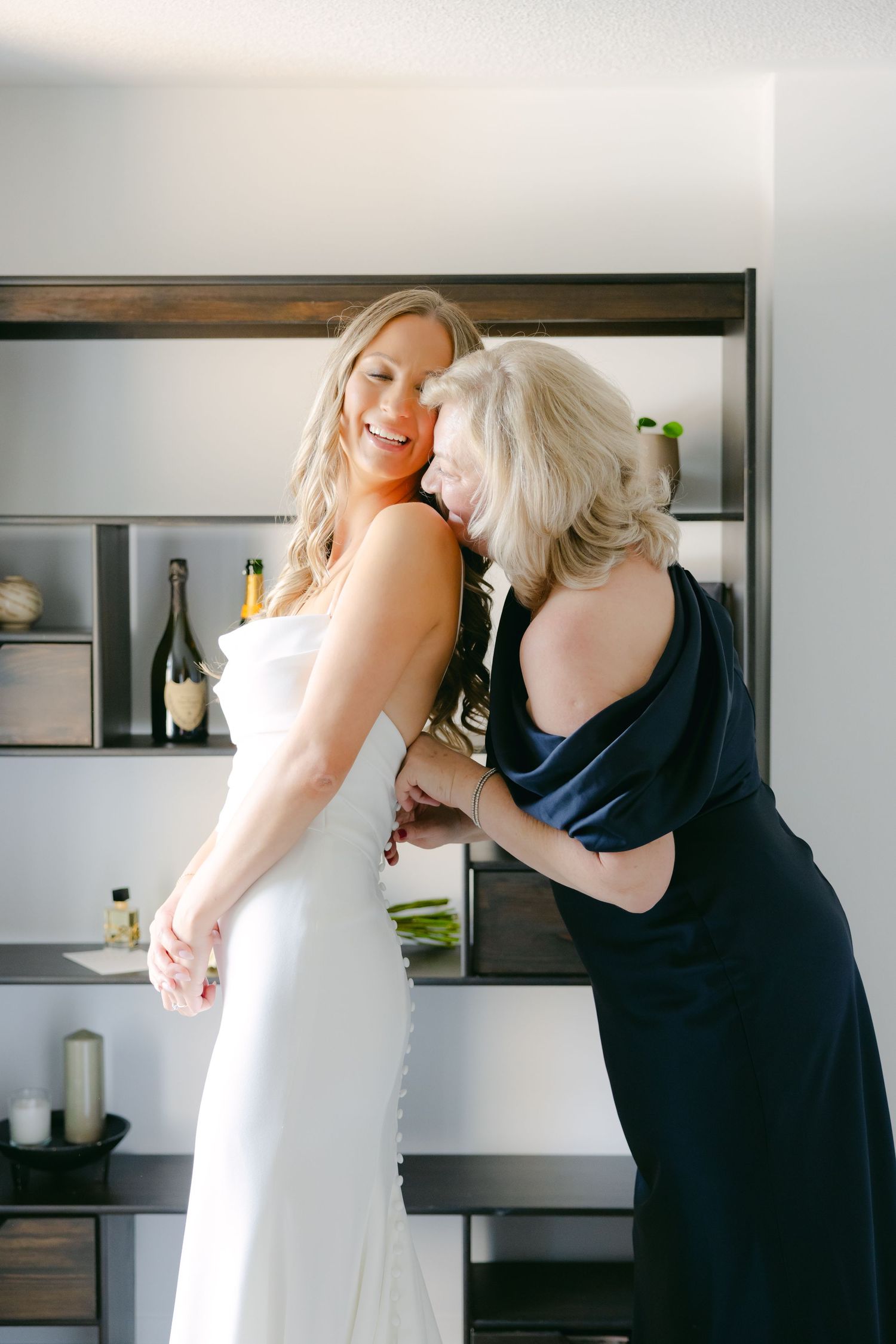Wedding preparations in a modern room with built-in shelving and natural light.