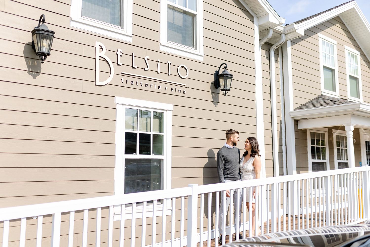 Exterior view of Clavetta restaurant with white railing and beige siding.