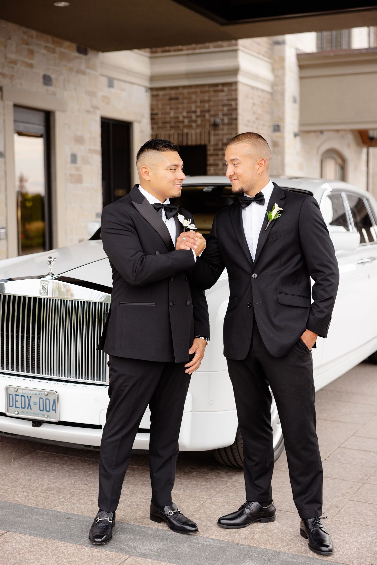 Four men in black tuxedos showing their colorful socks in a posed wedding party photo sequence.