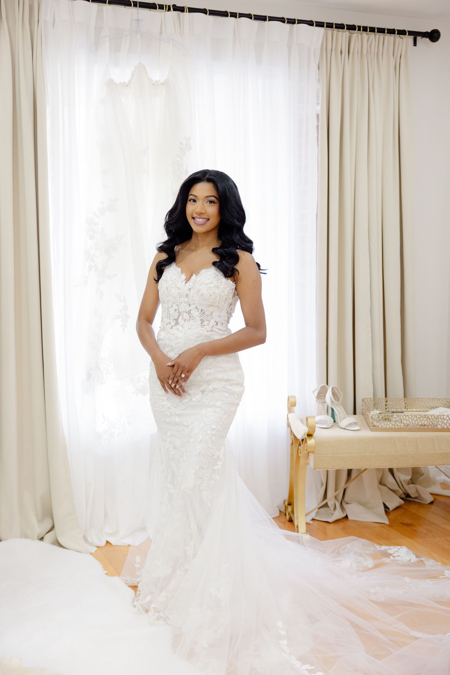 Elegant mermaid wedding dress with lace details photographed in natural light.
