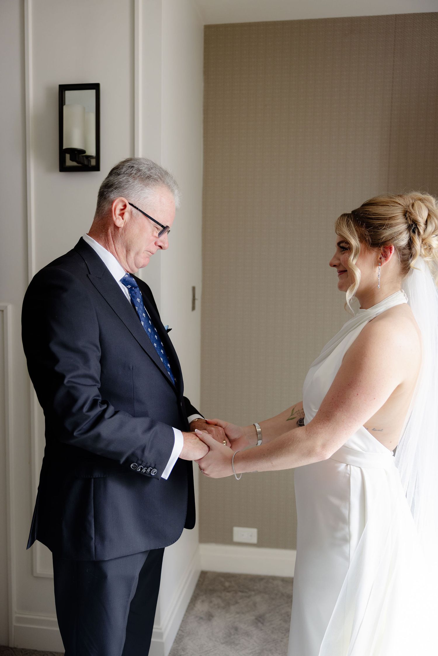A sequence of heartfelt reactions between a bride and her father during their first look before the wedding.
