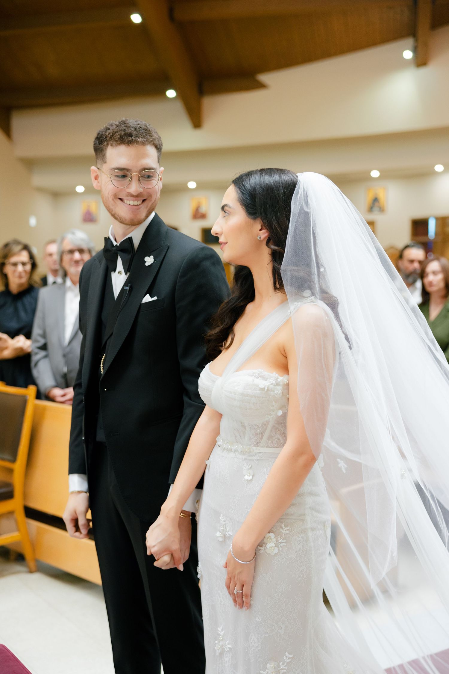 Bride and groom share a joyful moment together during their church wedding ceremony.