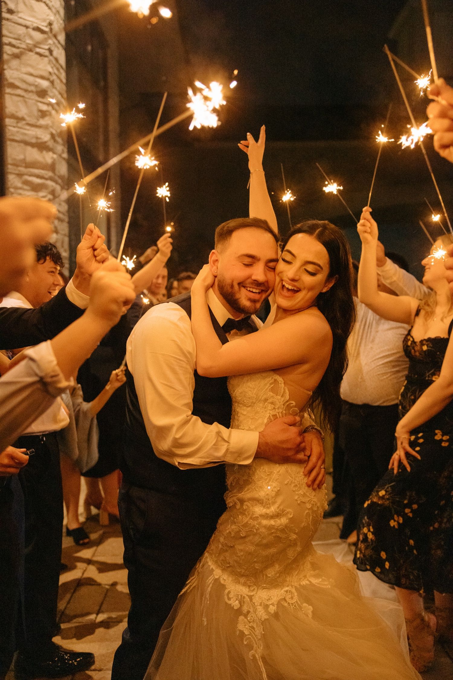 Sparkler celebration creating magical moments during an outdoor evening wedding reception.