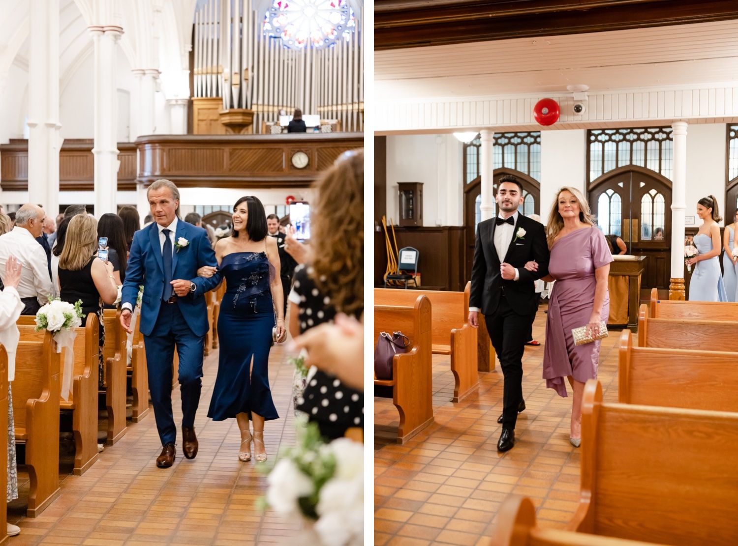 Wedding party members walking down church aisle decorated with floral arrangements.