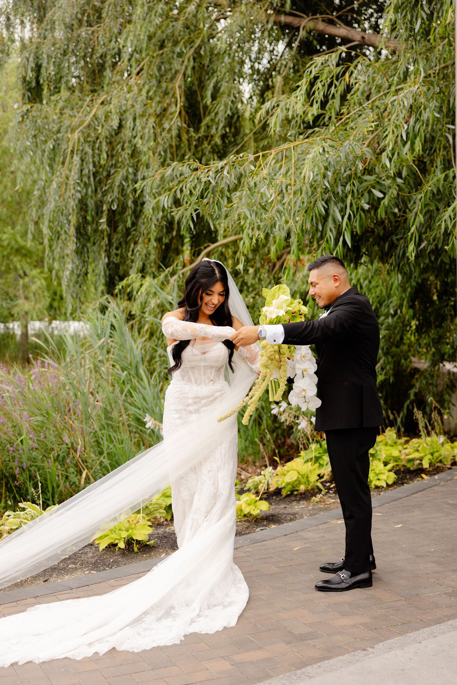 A romantic first look sequence of a couple on their wedding day beneath a weeping willow tree.