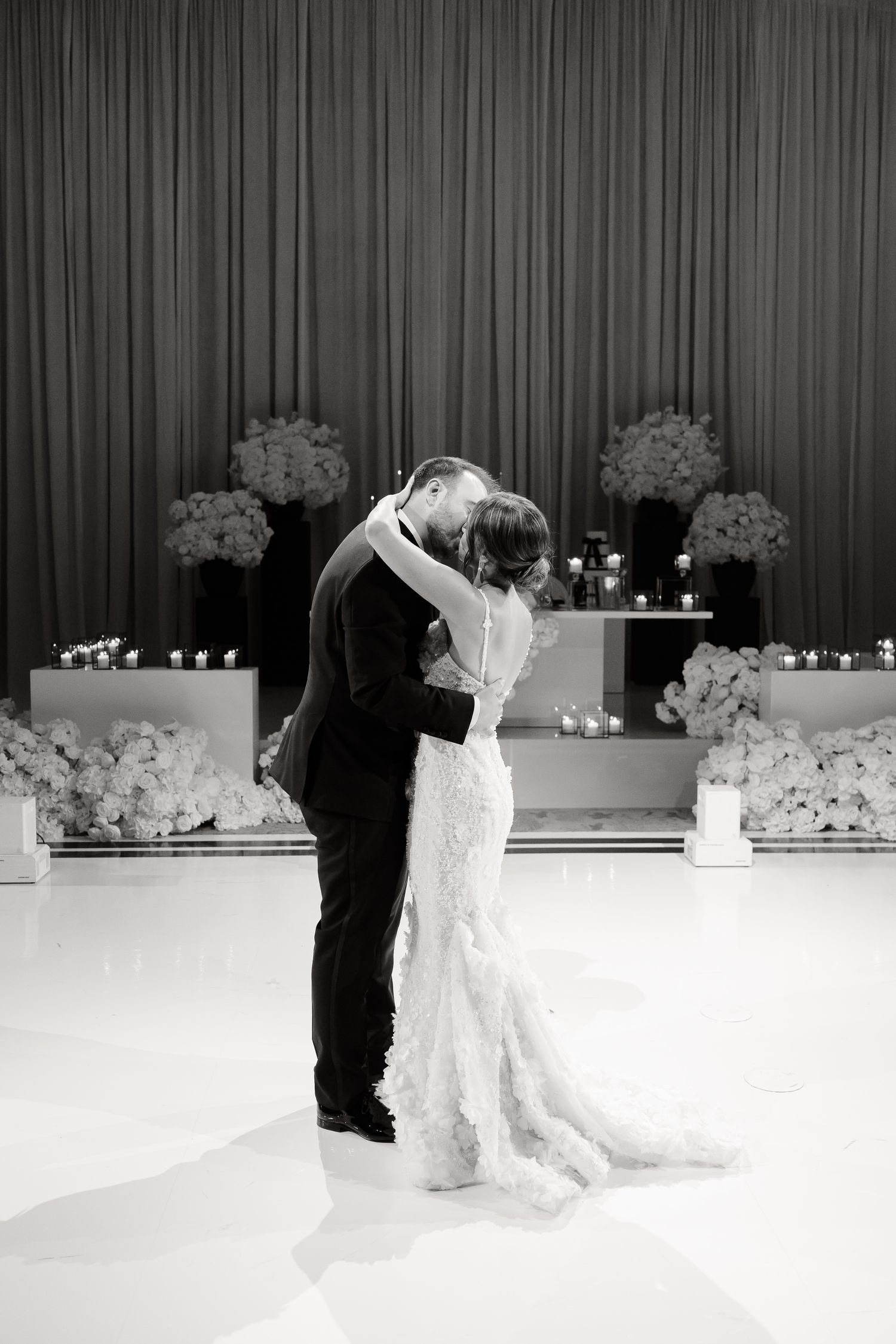 A sequence of black and white wedding photos showing a couples first dance with a dip finale at a formal reception.