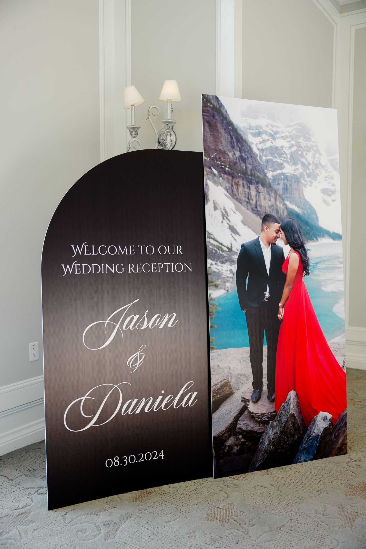 Curved welcome sign for wedding reception featuring mountain landscape photography.