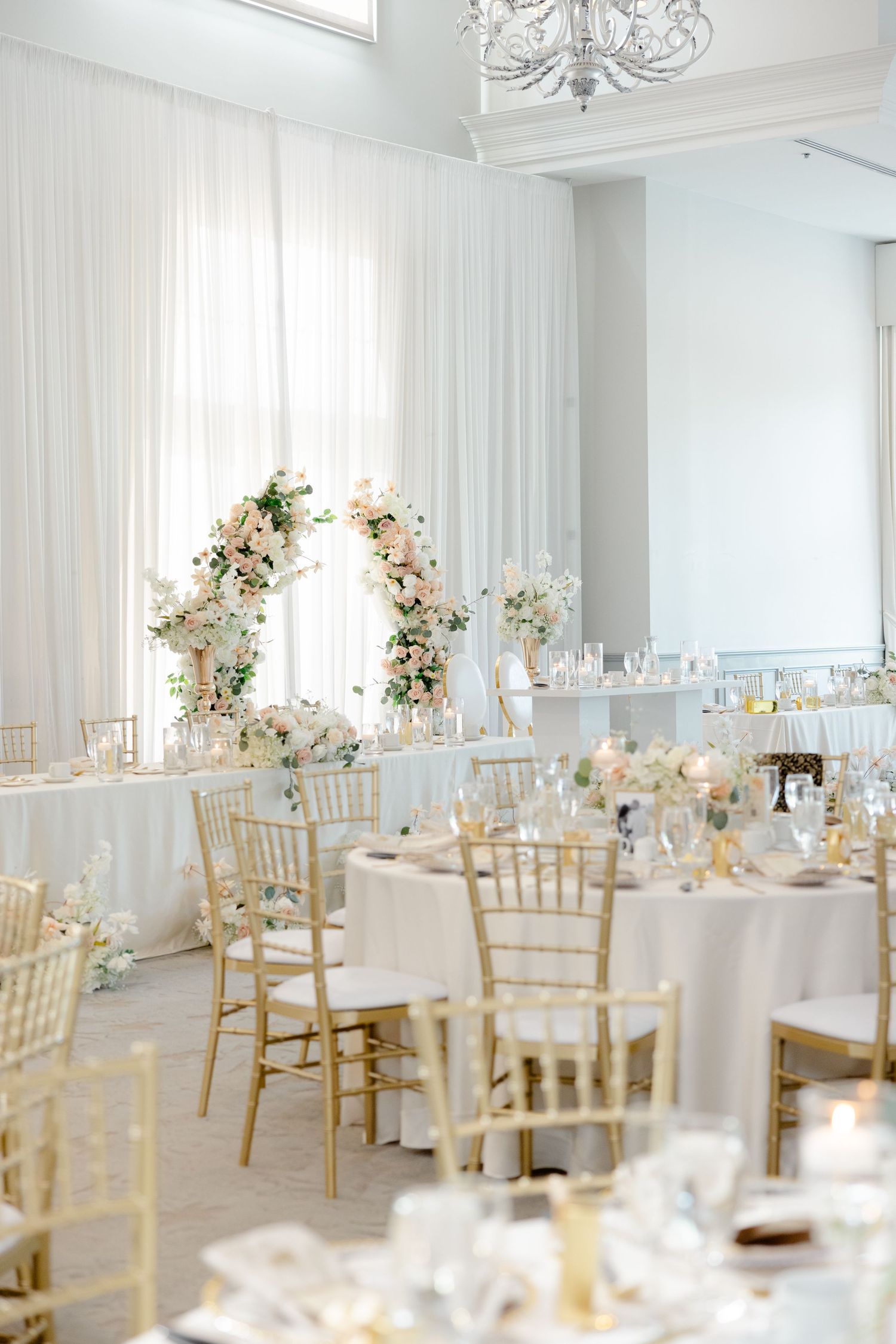Romantic moment during wedding reception in an elegant white room.