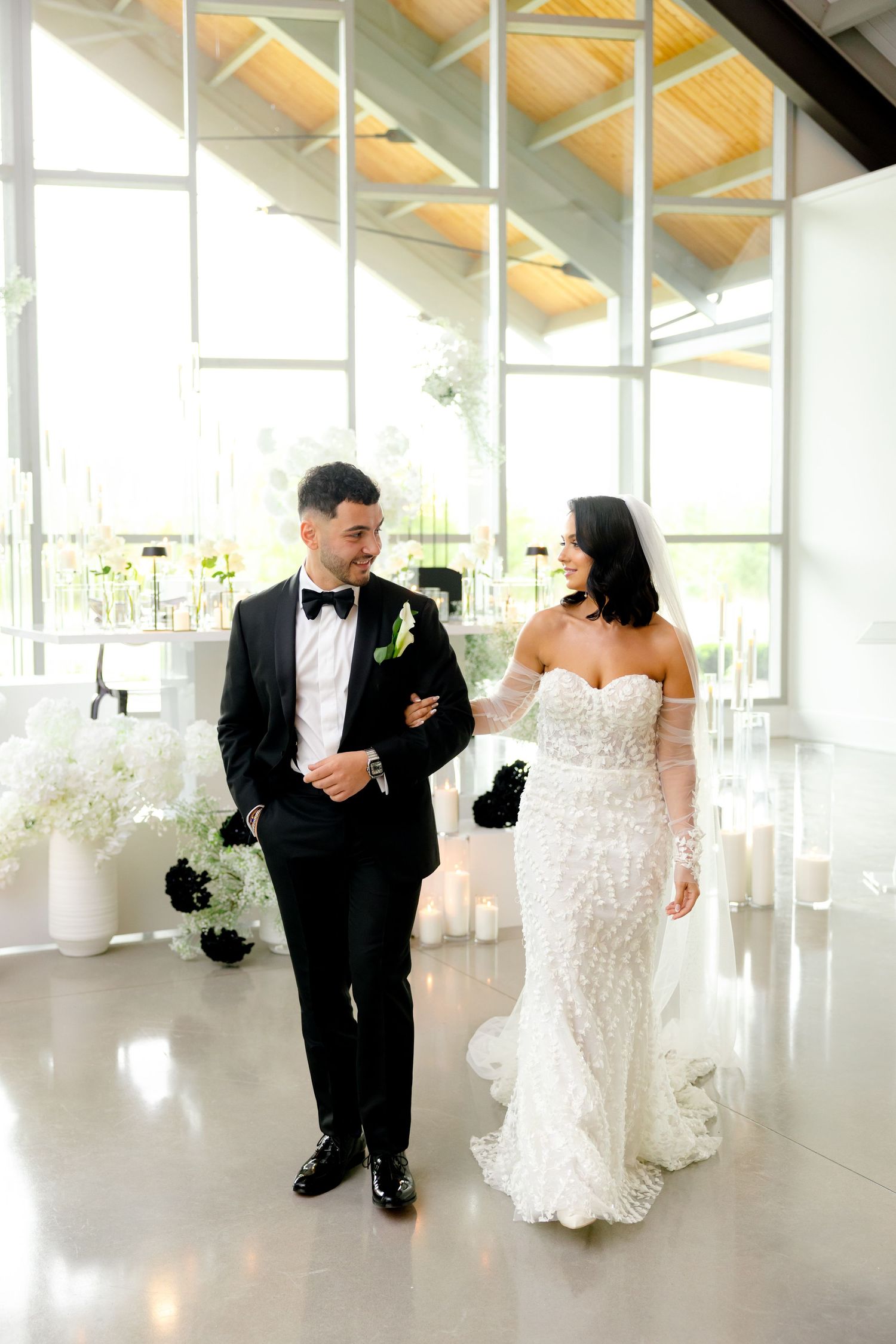 Modern wedding venue featuring dramatic architecture and natural lighting through large windows.