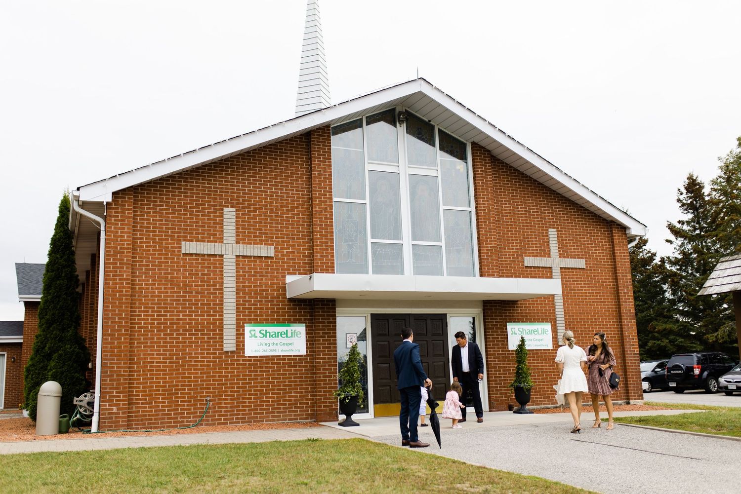 Brick church exterior with modern architectural features and white crosses.