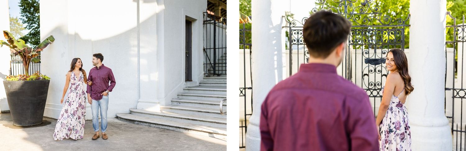 Couple in coordinated burgundy and floral outfits pose together near white columns on a sunny day.