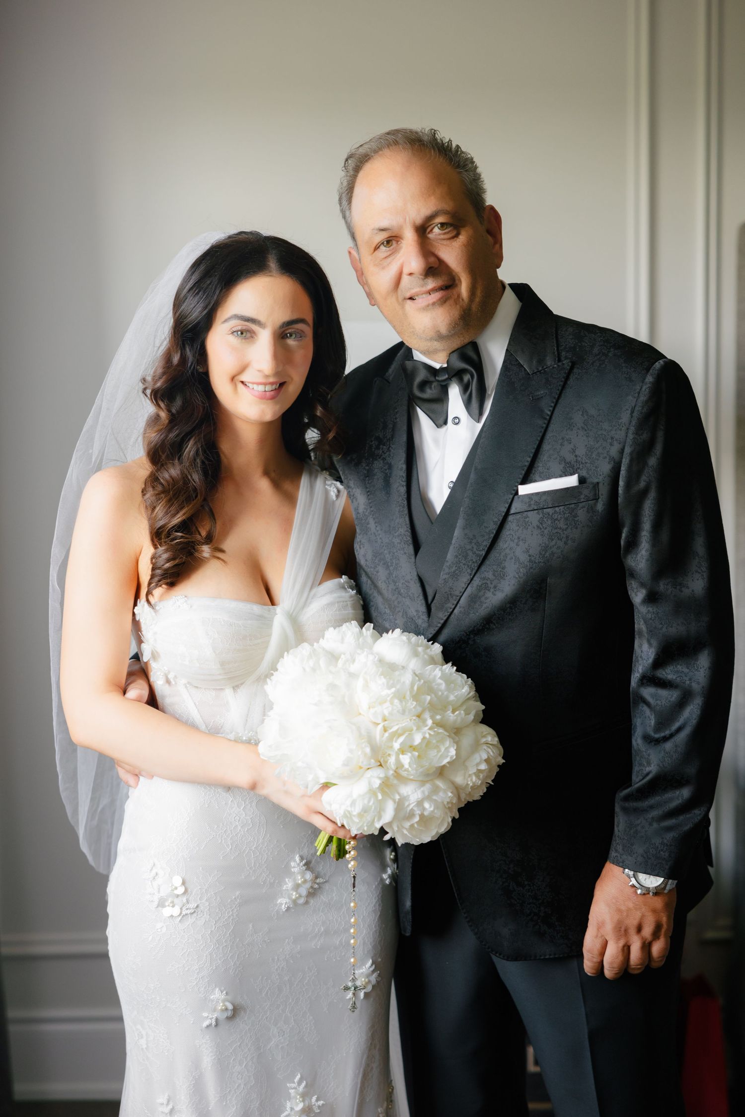 A heartwarming wedding portrait captured by a window with natural lighting.