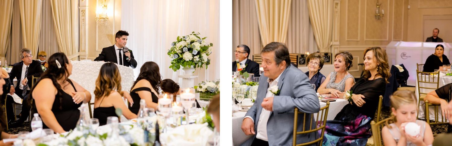 Wedding guests engaged in lively conversation at elegant reception tables decorated with white floral centerpieces.