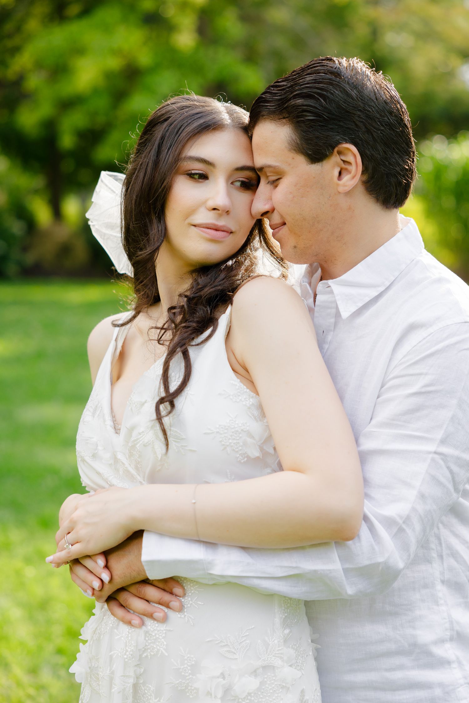A tender portrait moment in a garden setting with natural light.