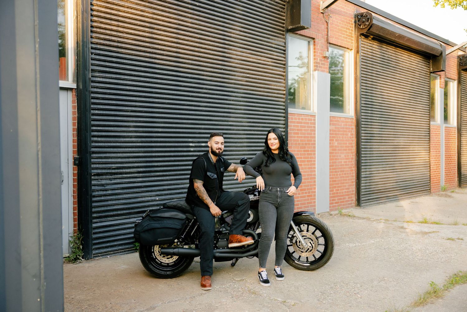 A relaxed motorcycle photoshoot against an industrial backdrop with metal shutters.