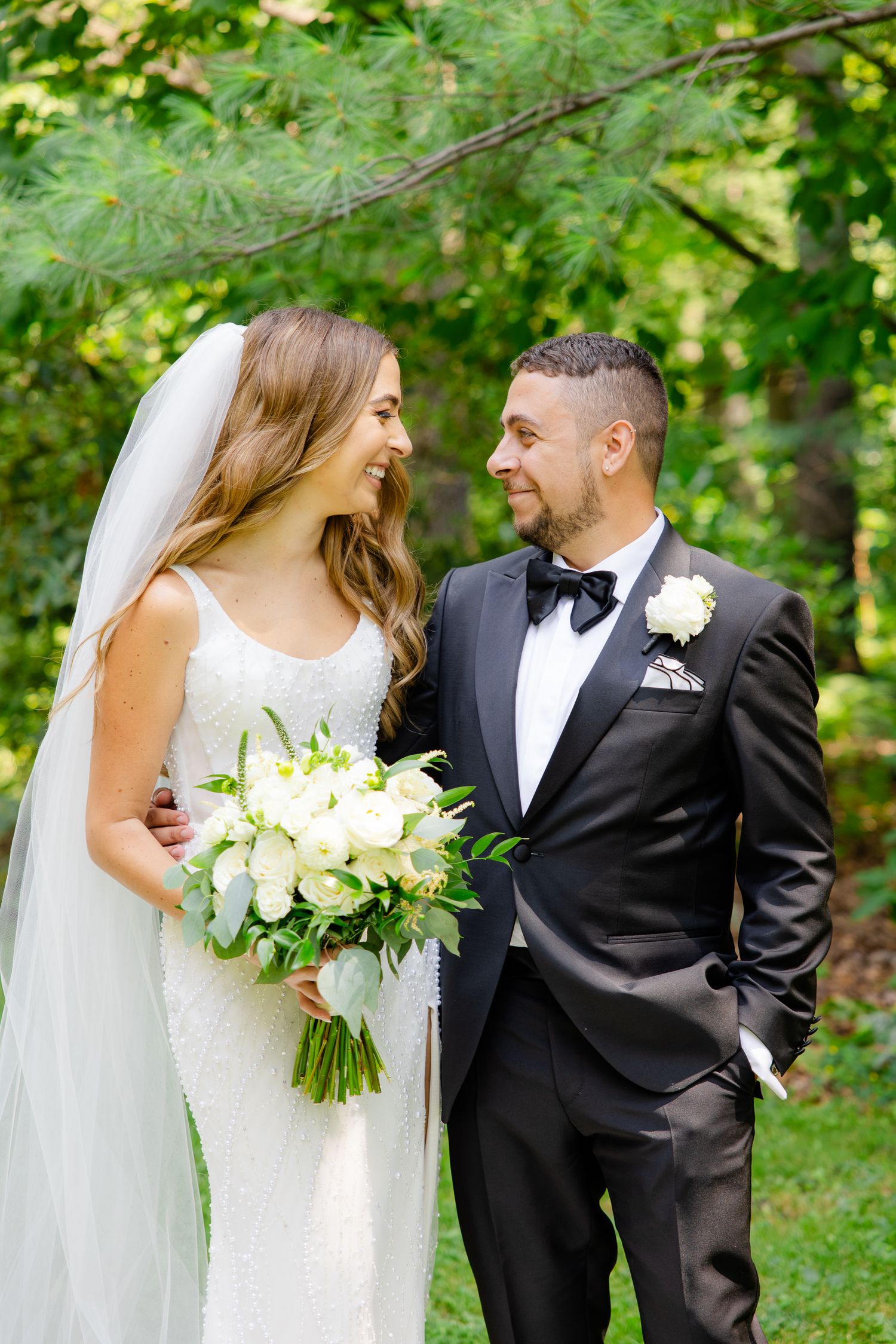 Candid wedding moment captured in a natural garden setting.