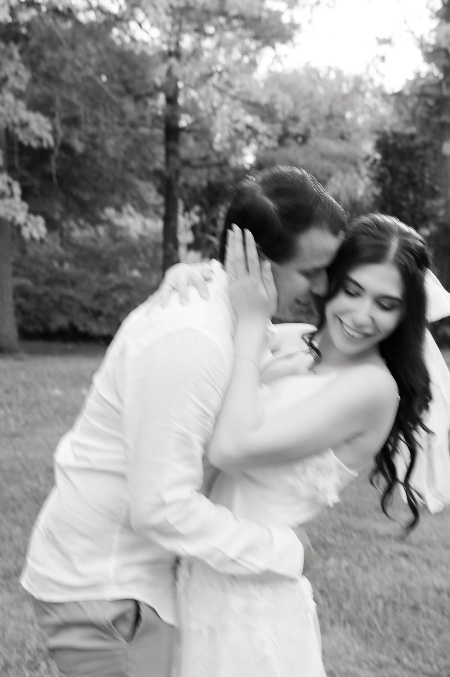 Black and white photo of a couple sharing a tender embrace during their wedding shoot.