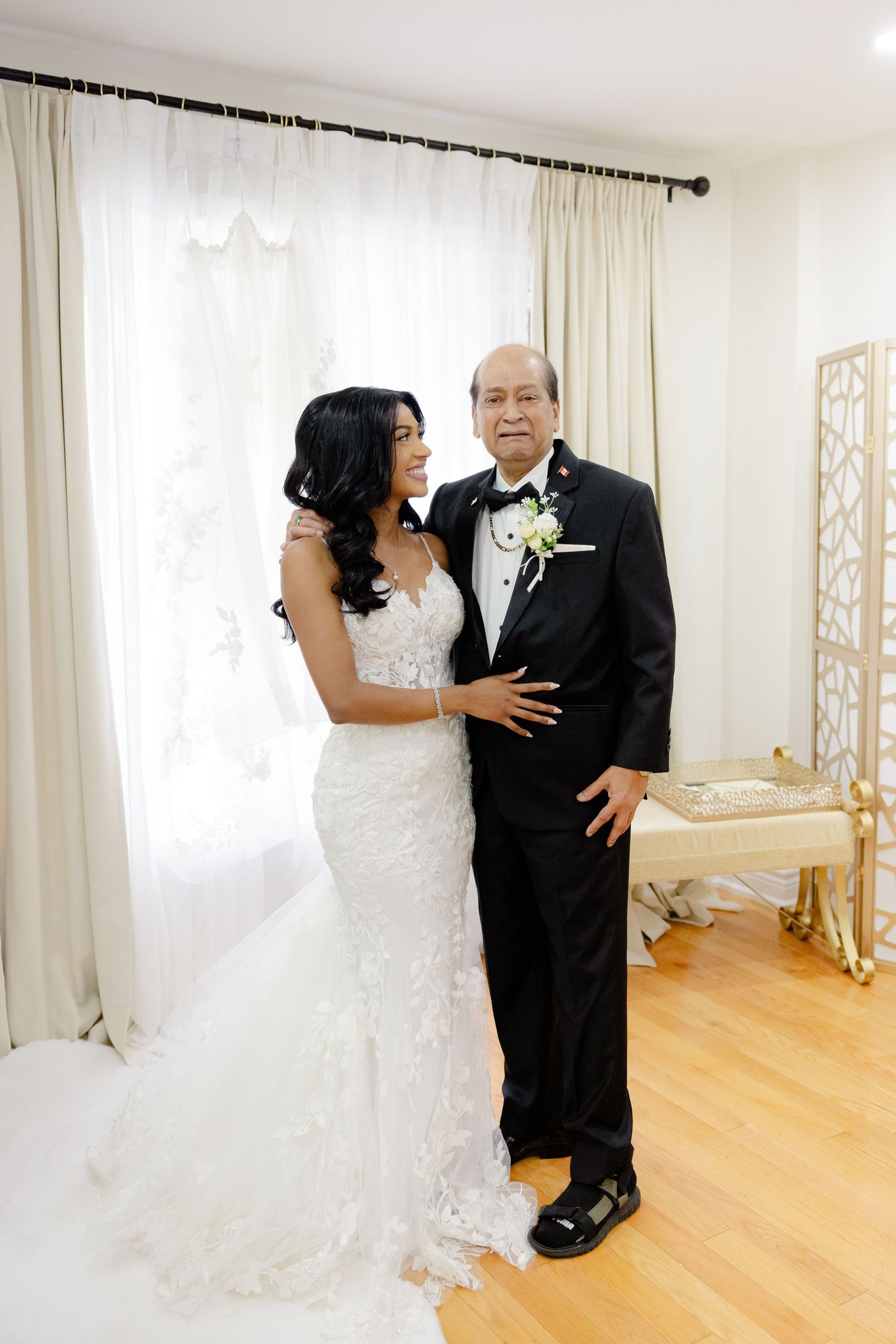 Intimate wedding portrait showing tender moment between family members in formal attire.