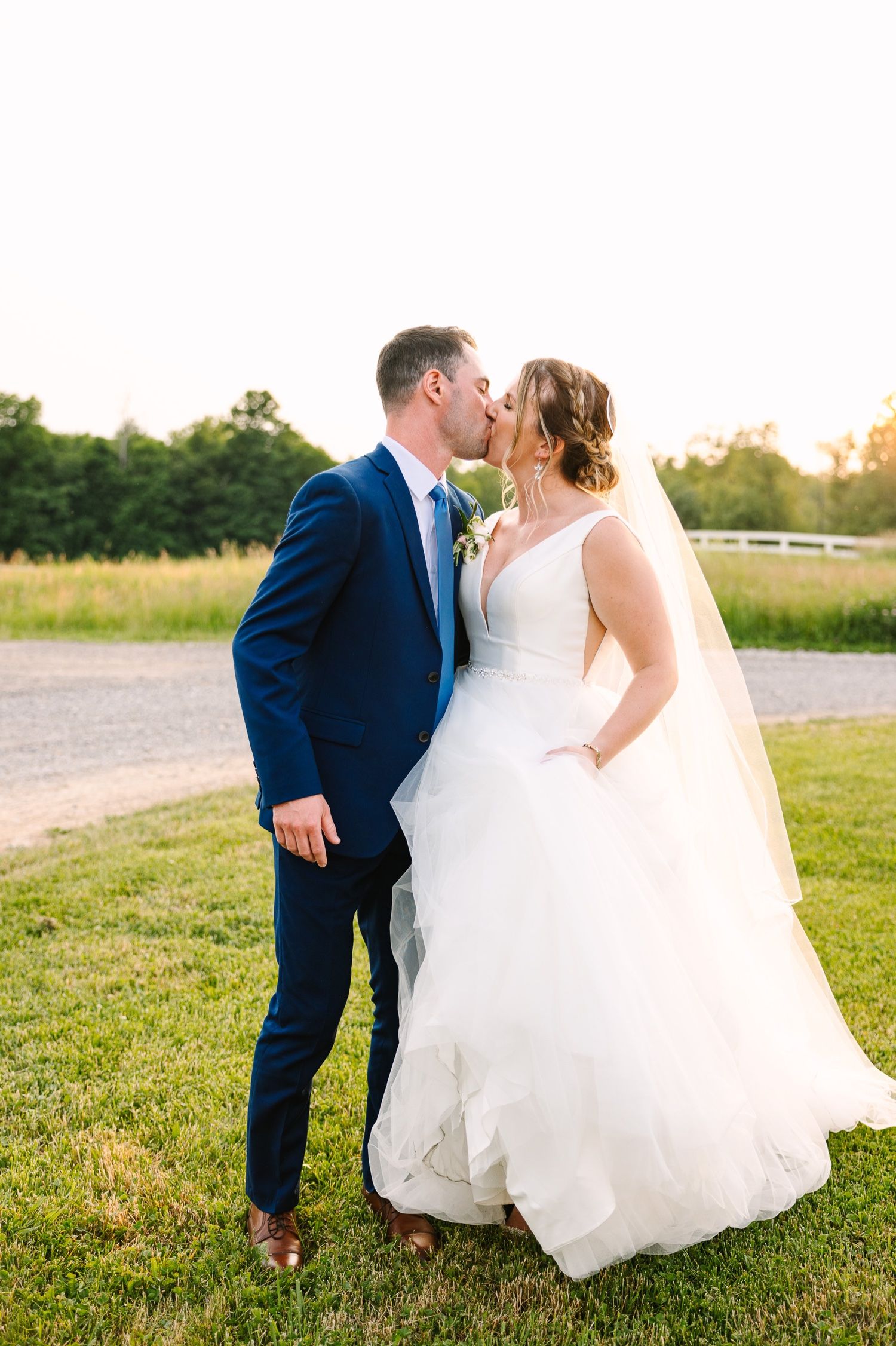 A tender wedding moment captured between a couple in a scenic outdoor setting.