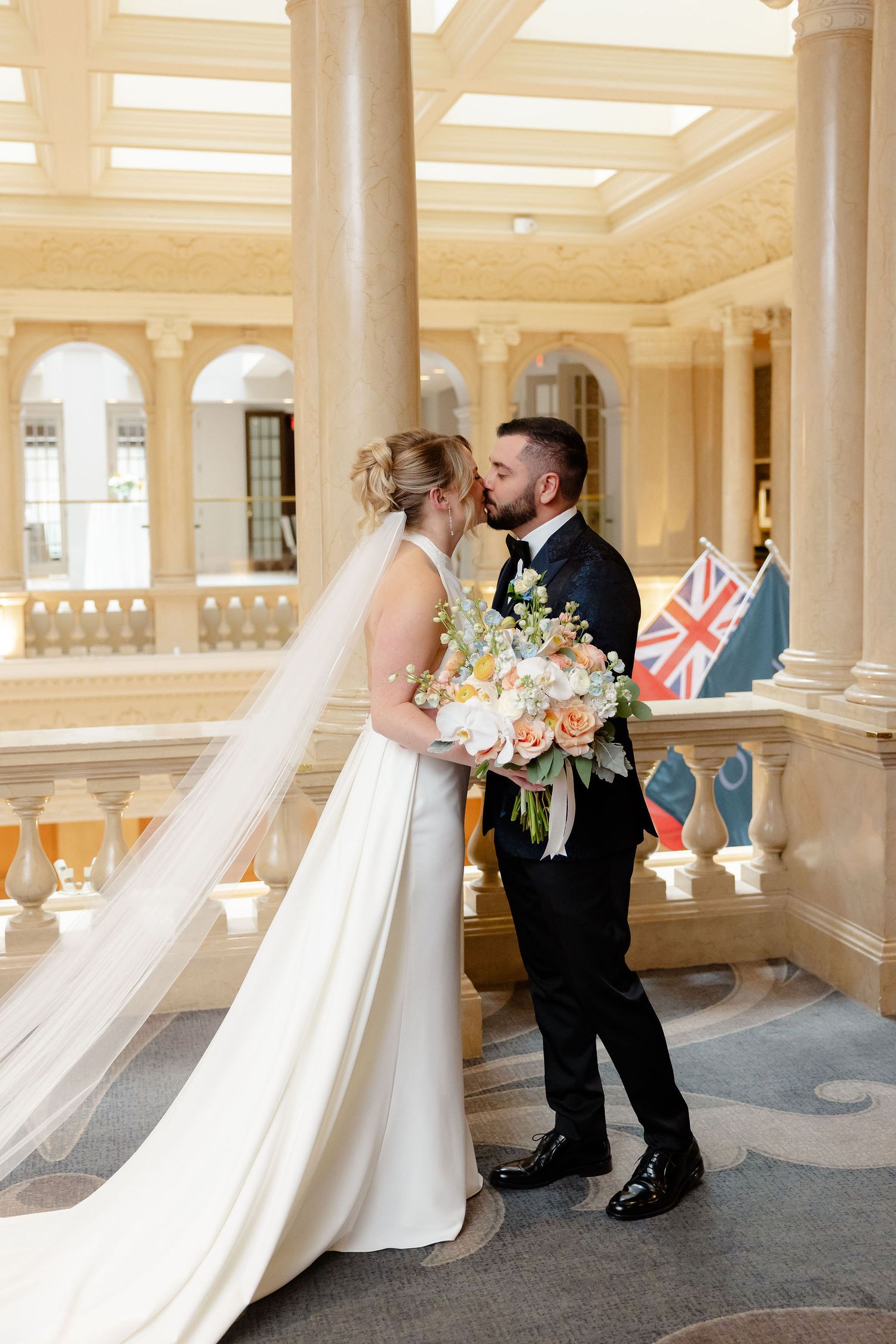Candid wedding photos showing couple's interaction in an elegant indoor venue with columns.