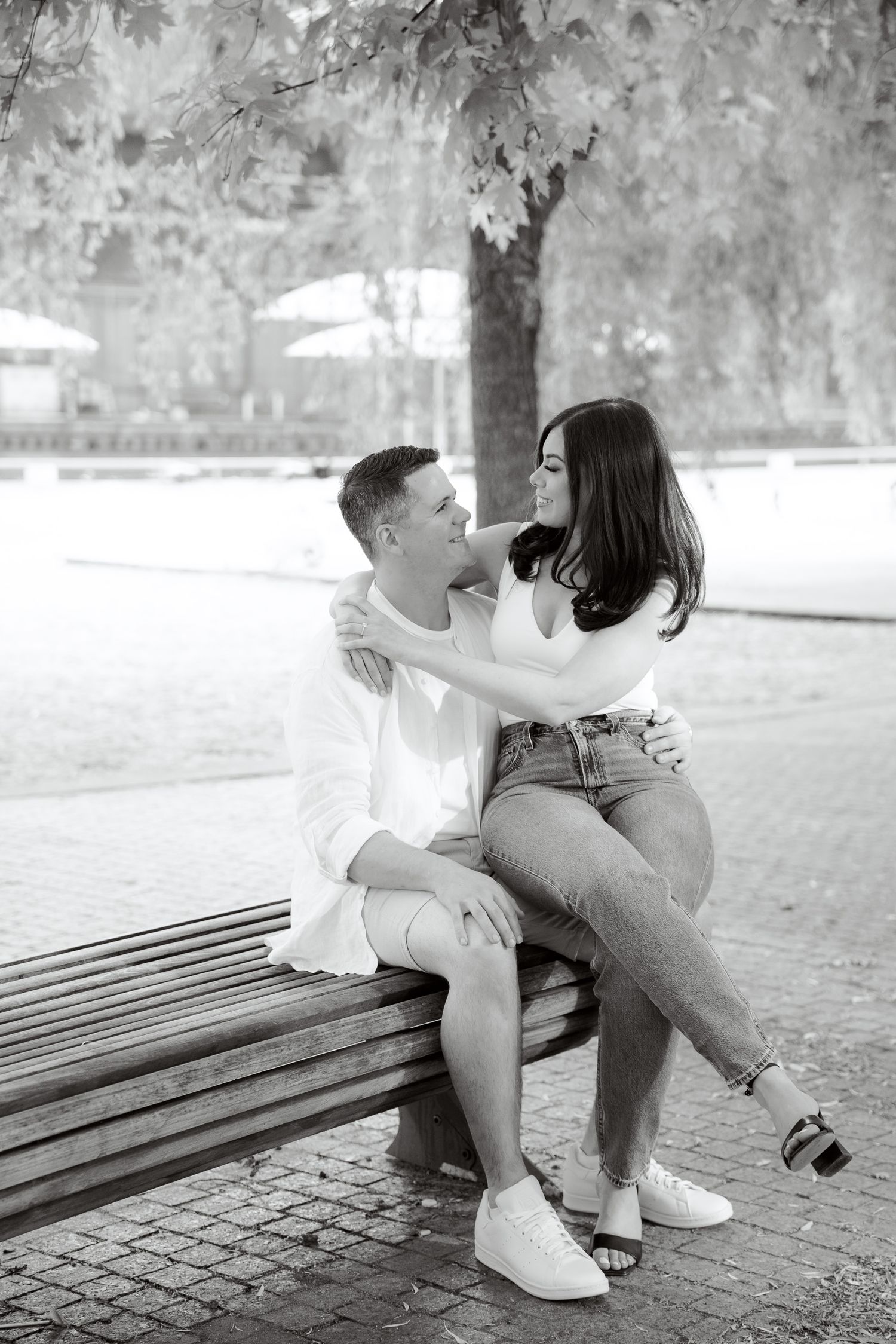 A tender black and white moment captured of a couple on a park bench.