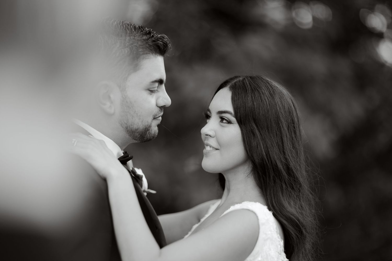 Black and white romantic portrait of newlyweds in an intimate close-up.