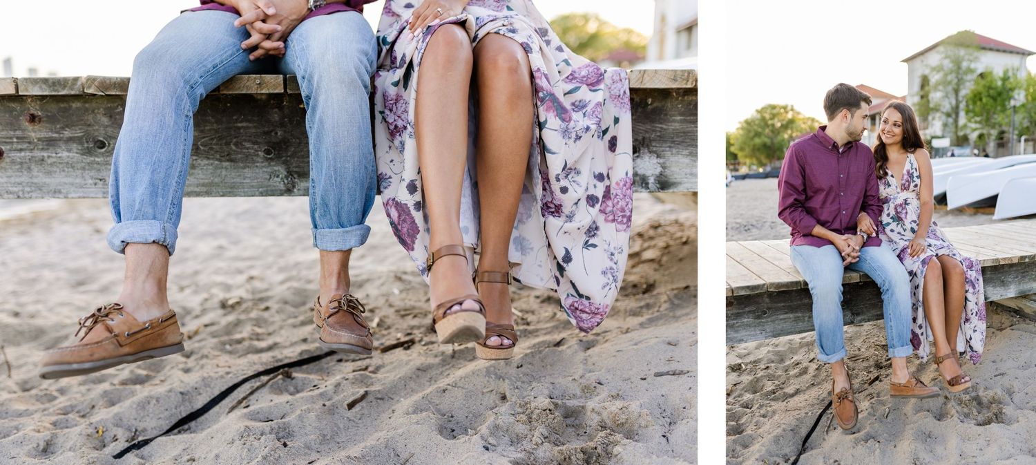Close up of feet and legs sitting on wooden dock by the water.