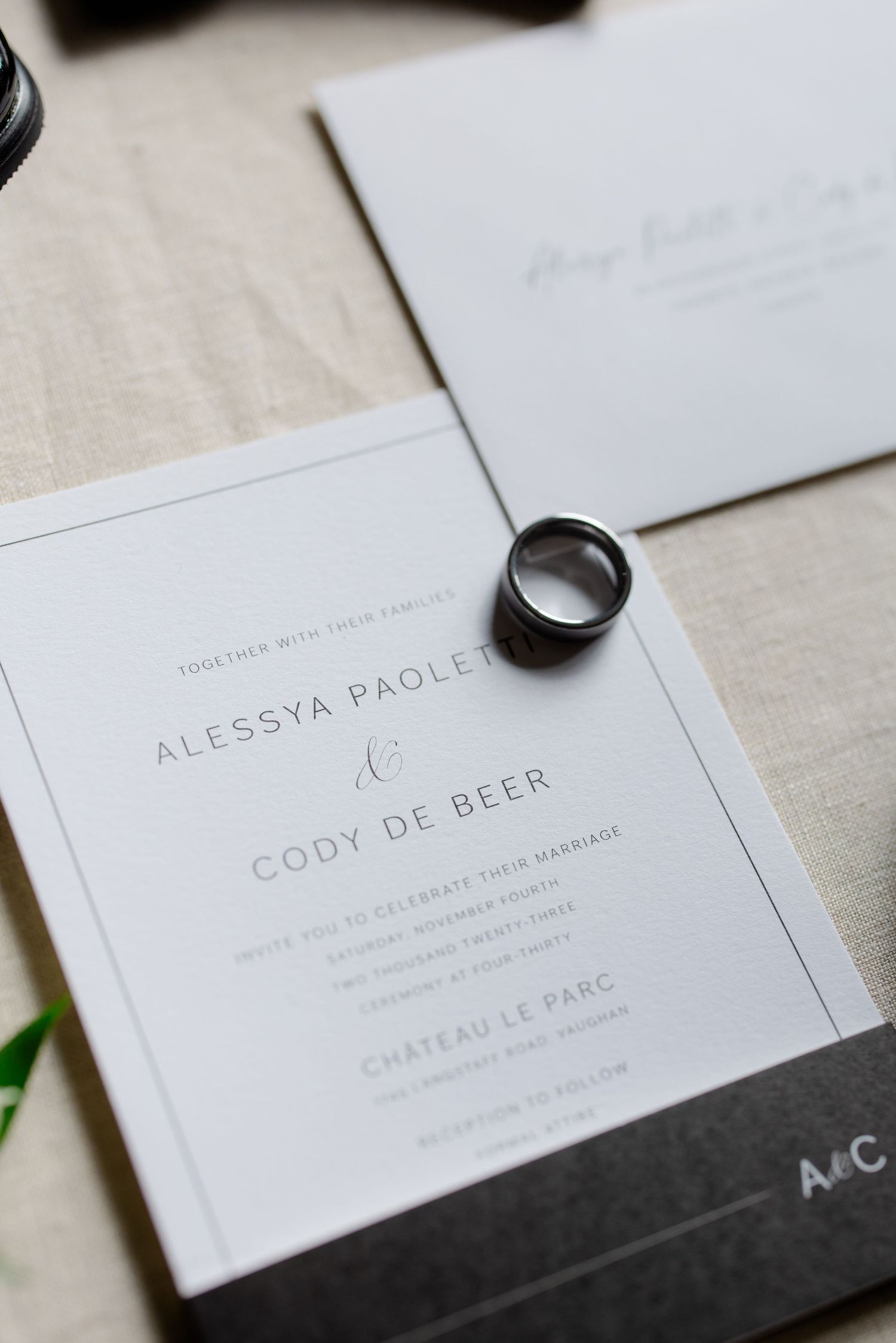 Elegant wedding invitation for Alessya and Cody with wedding ring detail.