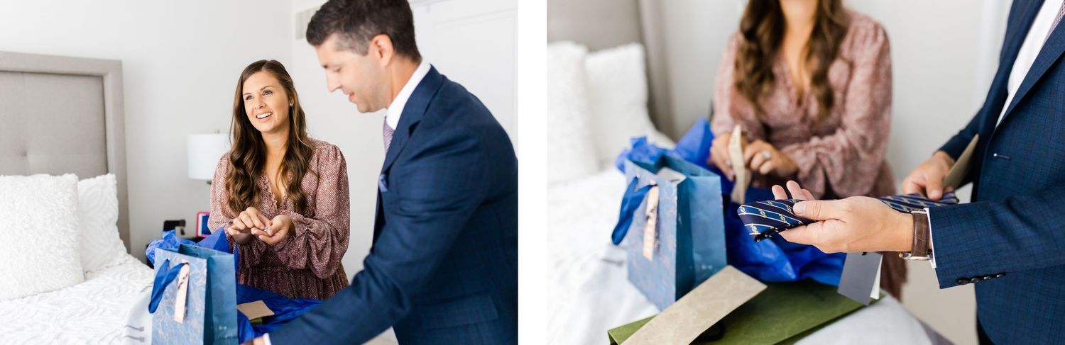 Couple opening blue-wrapped presents on a bed.