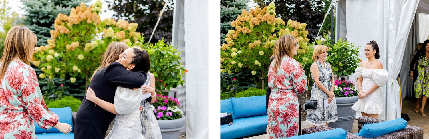 Wedding celebration moment captured under white tent with floral decorations.